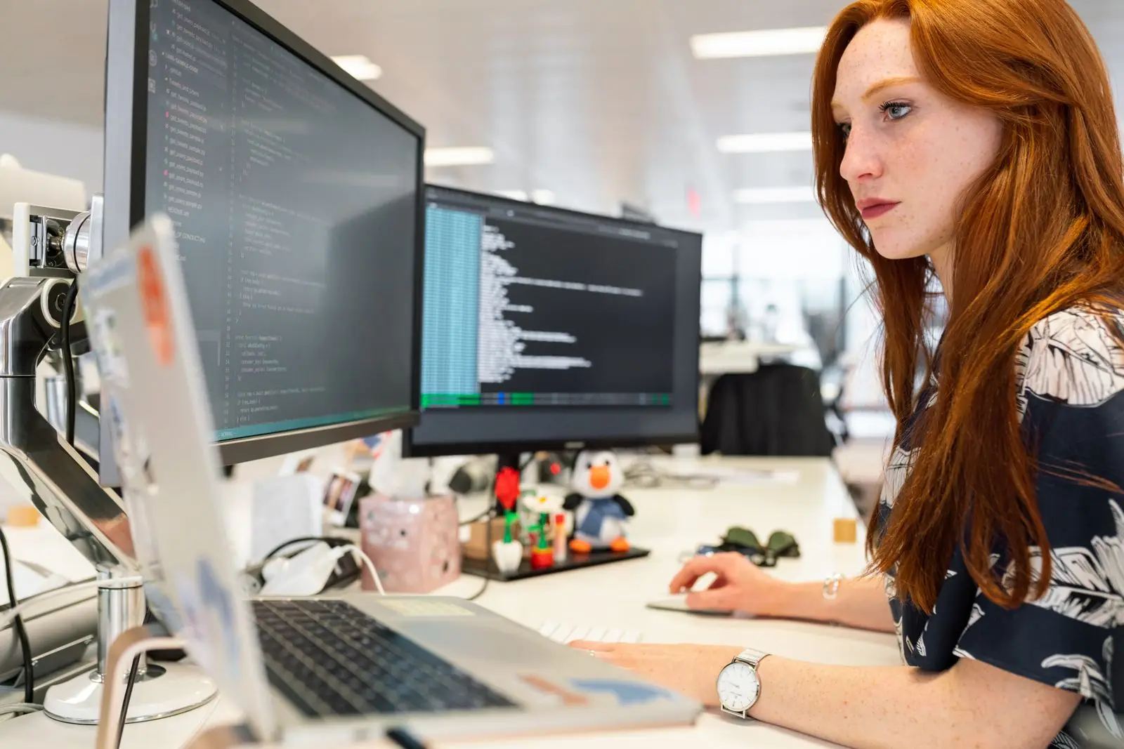 Engineer reviewing test results across several monitors