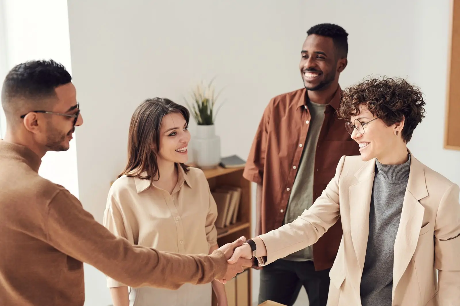 Colleagues greeting each other in an open office