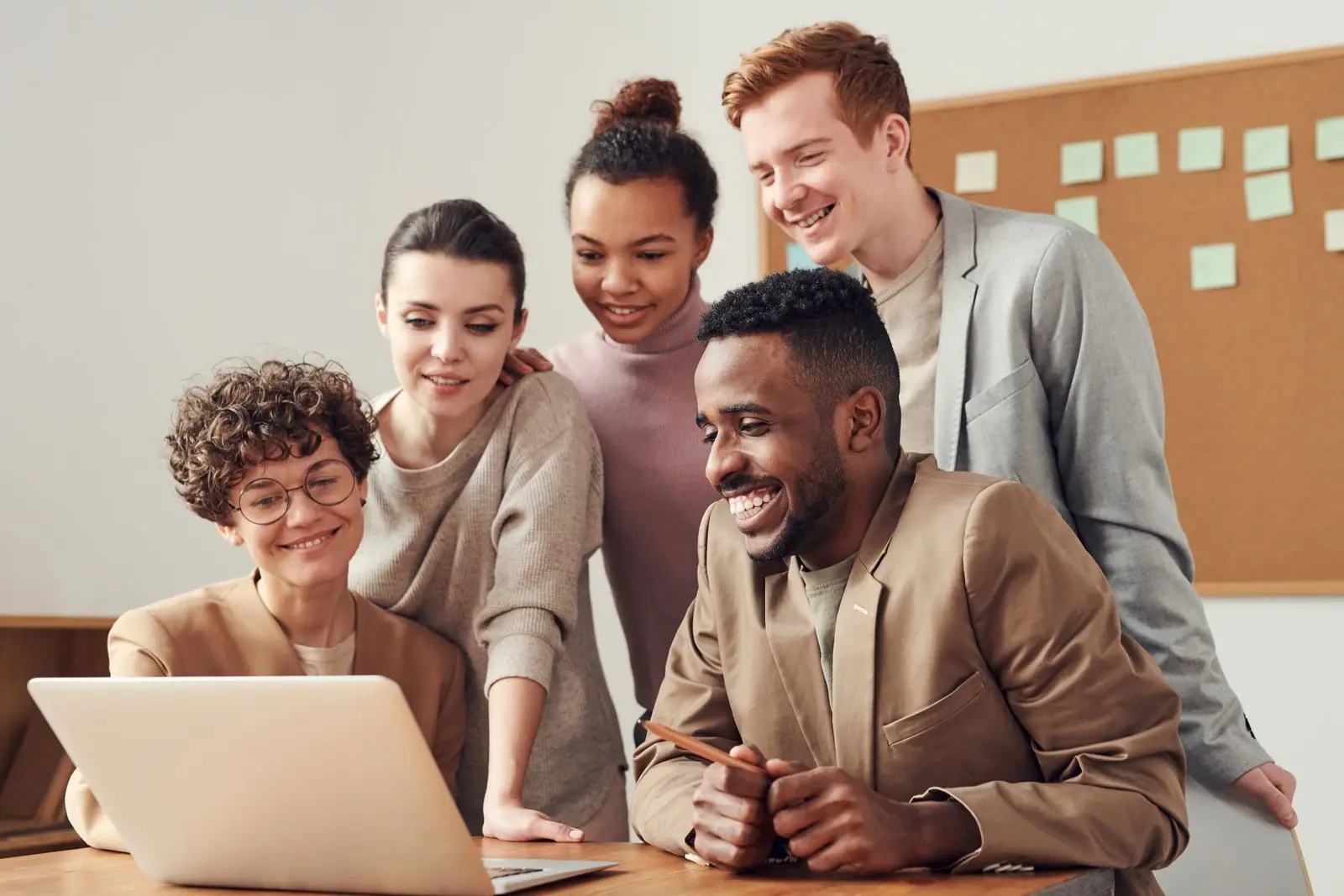 Engineers reviewing work together around a laptop